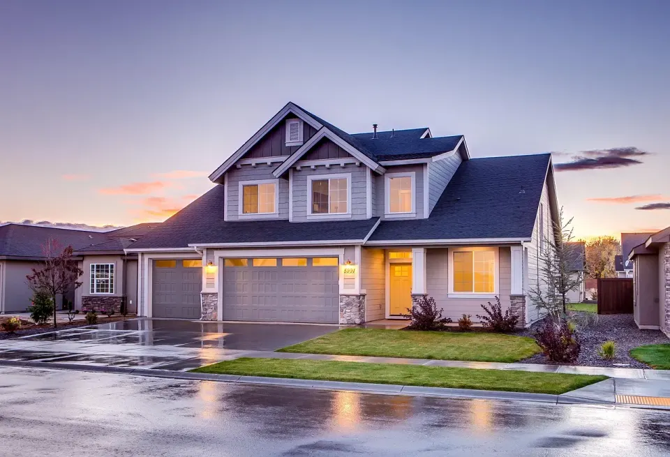 A suburban house with a garage and driveway, the kind of neighbor a spoofed local number pretends to be