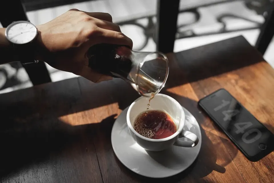 A cup of coffee on a cafe table, like the casual coffee invite many wrong number texts open with
