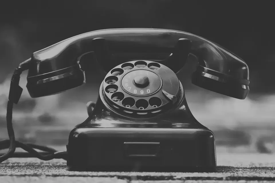 A vintage telephone in black and white, from the era when the phone network trusted every caller
