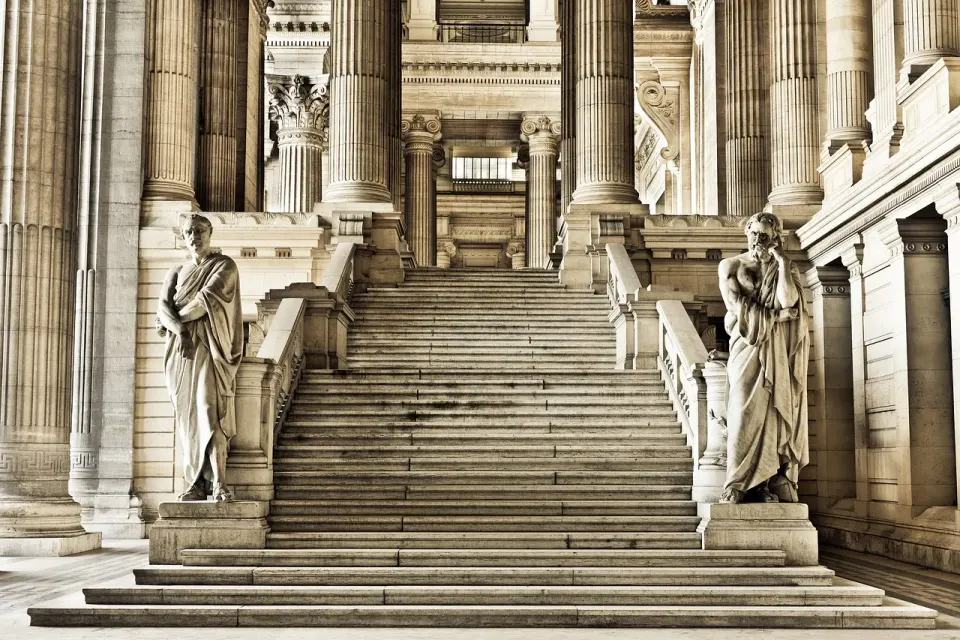 The columns of a large courthouse, where fake AI citations are increasingly caught