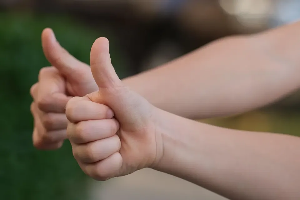A hand giving a thumbs up, the sort of approval signal used to train chatbots